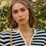 Woman wearing a 14k gold Diamond Rondelle Bead pendant necklace with lab-grown diamonds on a box chain