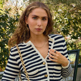 Woman wearing a Diamond Rondelle Bead necklace in 14k gold with lab-grown diamonds, styled with a striped sweater outdoors