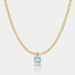 14k gold necklace with a sky blue topaz pendant featuring a square-cut gemstone in a gold basket setting