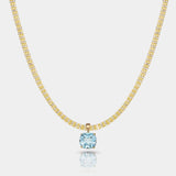 14k gold necklace with a sky blue topaz pendant featuring a square-cut gemstone in a gold basket setting