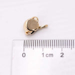 18K yellow gold pendant setting for Mexican Fire Opal necklace next to ruler for size comparison