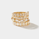 Stacked gold rings with bezel-set oval cut lab-grown diamonds in an eternity design