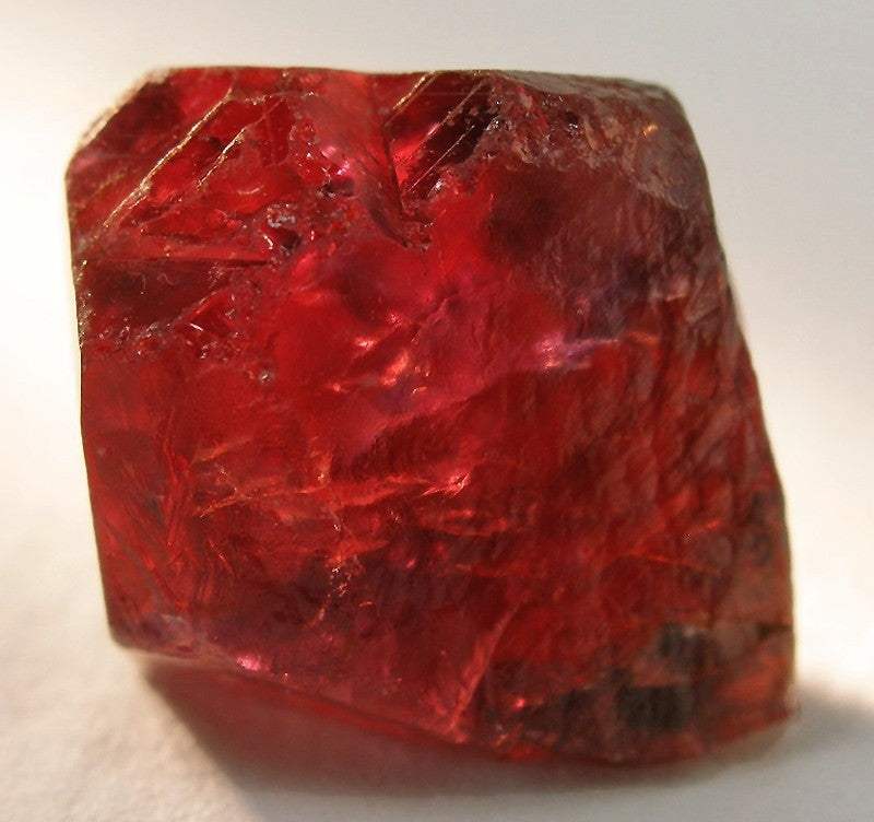 Close-up of raw red ruby gemstone, the July birthstone, showcasing its deep red color and natural crystal texture.