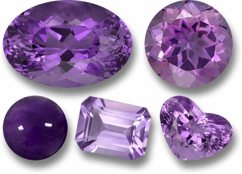 Various cuts of purple amethyst gemstones, February birthstone, displayed on a white background.