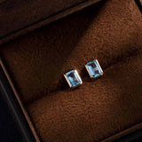 Emerald Cut Blue Topaz Stud Earrings in 14K Yellow Gold