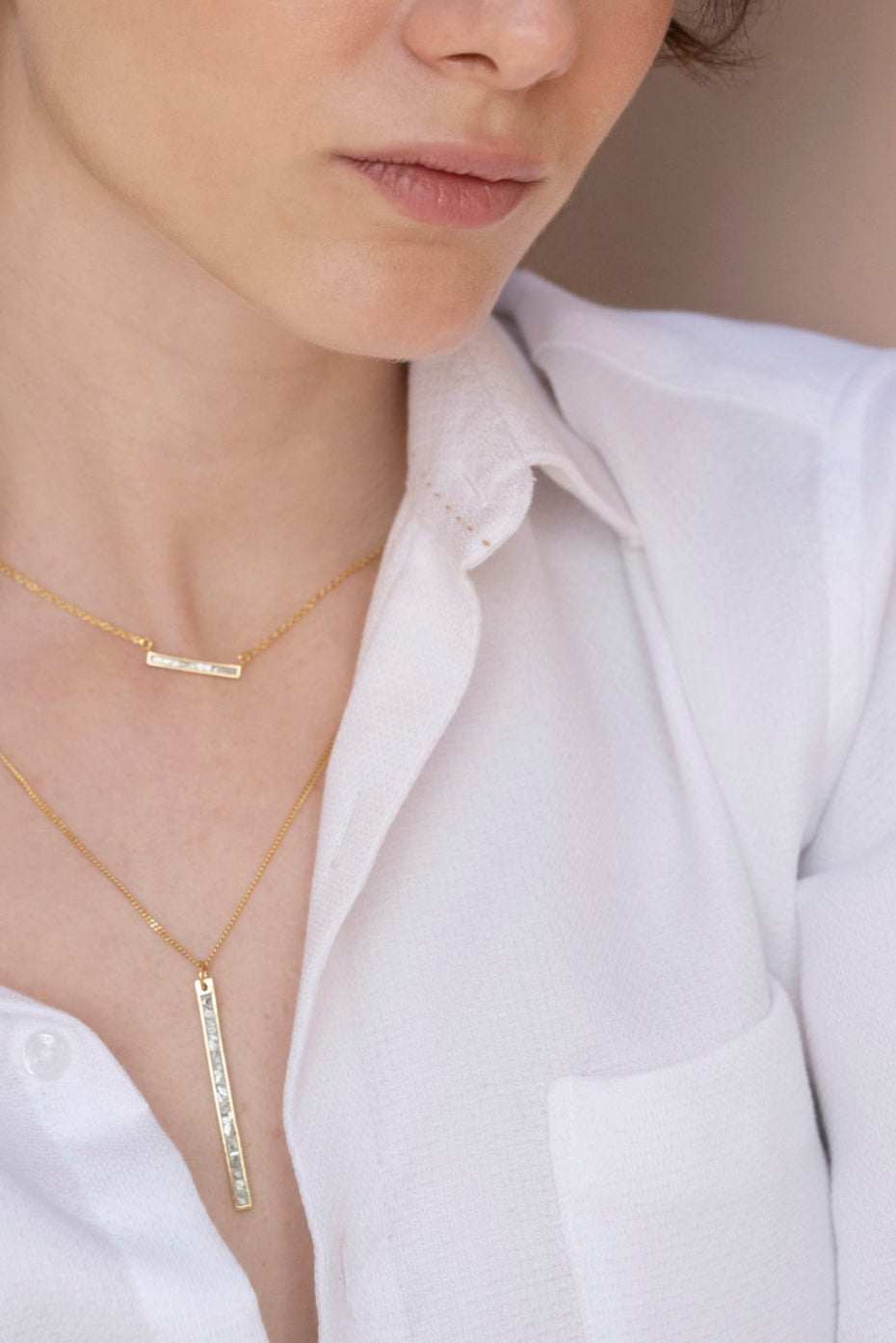 Emlyn Gold Vermeil Pendant necklace with minimalist bar design on fine gold chain worn with white shirt