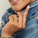 Michelle Gold Vermeil ring with thin diamond line and black diamond trim on woman's hand wearing denim jacket