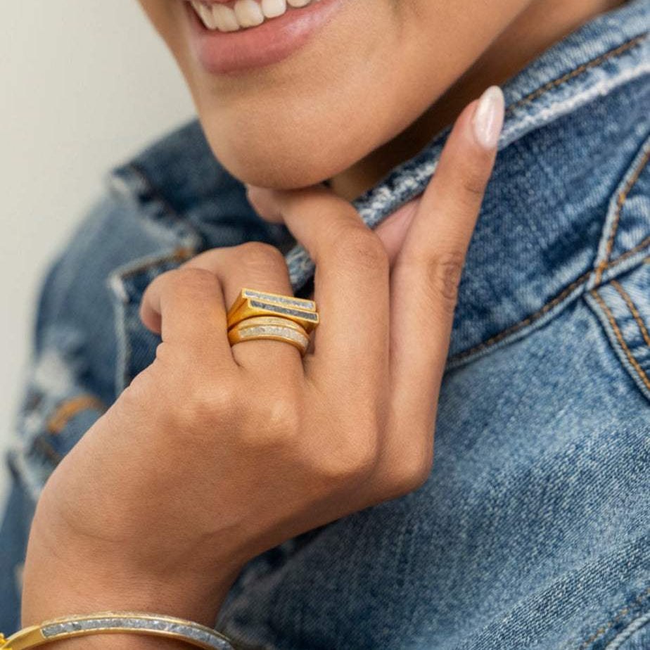 Michelle Gold Vermeil ring with thin diamond line and black diamond trim on woman's hand wearing denim jacket