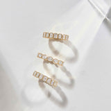 Solid gold bezel set emerald cut diamond eternity bands inspired by Nauset Light lighthouse