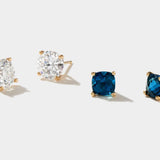 Lab grown diamond stud earrings in 14k gold with round white and blue stones.