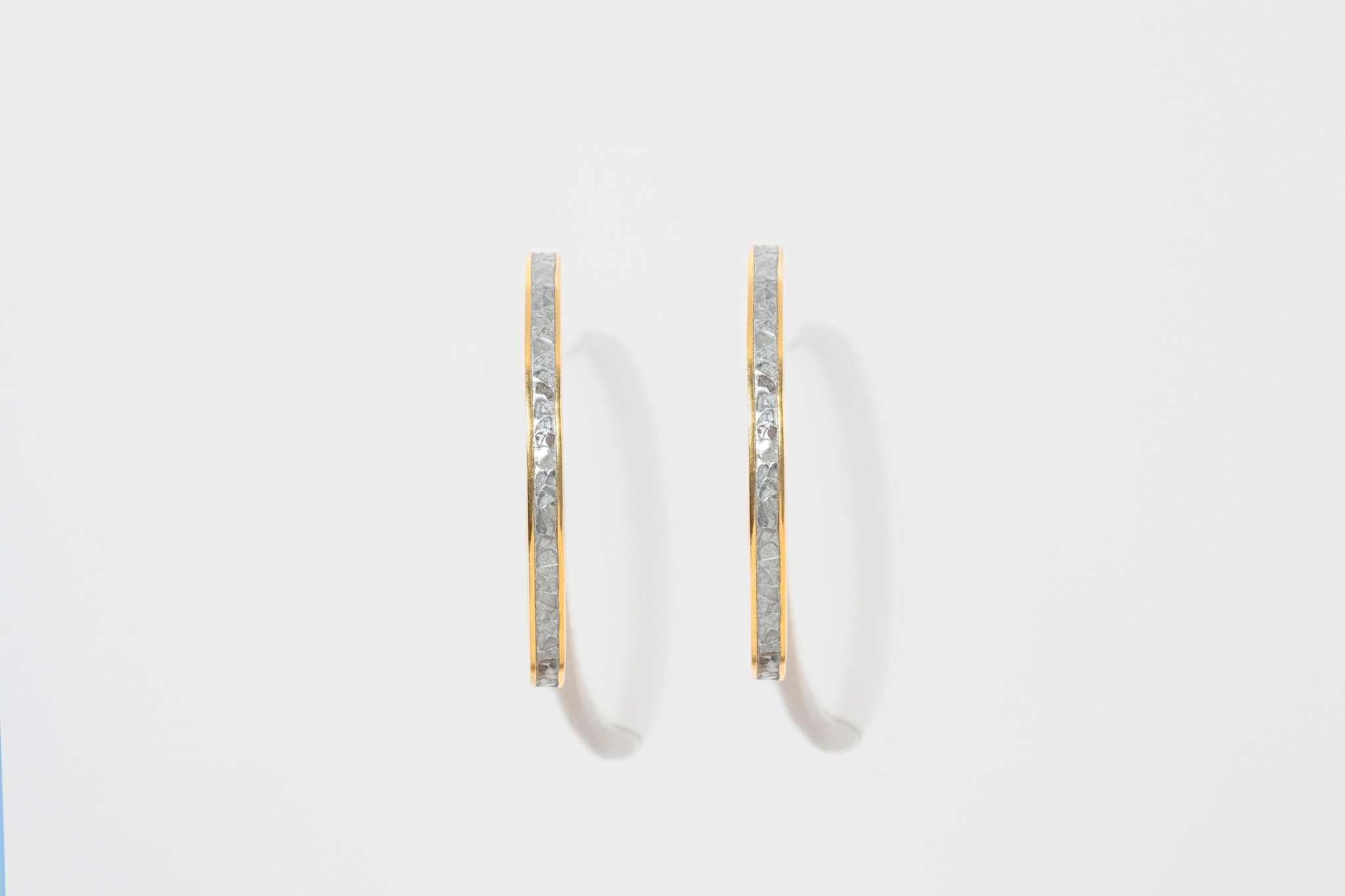 Pair of Hapur Gold Vermeil Hoop Earrings with textured silver resin and 18k gold edges.
