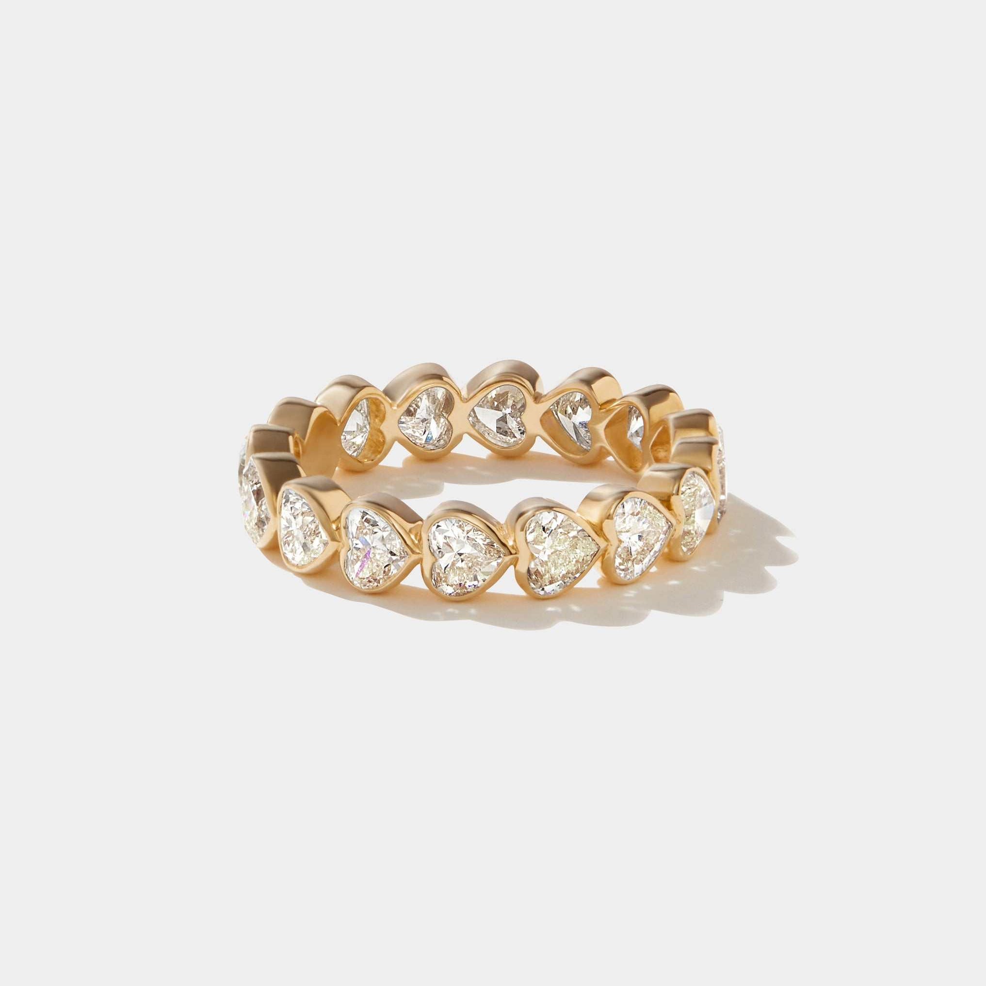 14k gold bezel set eternity ring with heart-shaped lab-grown diamonds totaling 2.4 carats