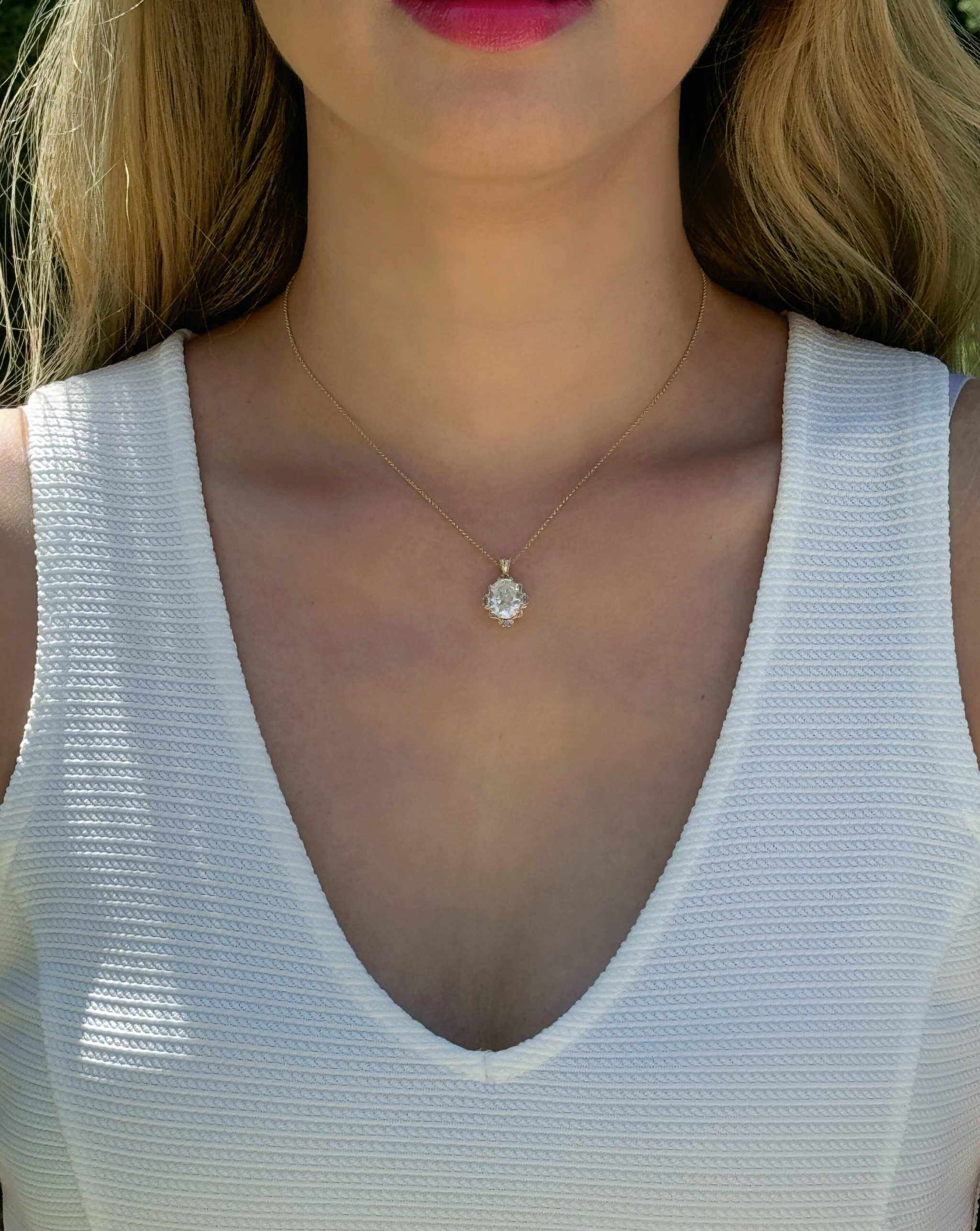 14K yellow gold pendant with 4.2 CT oval moissanite center and 4 natural alexandrite stones in vintage inspired mirror style worn on a delicate chain