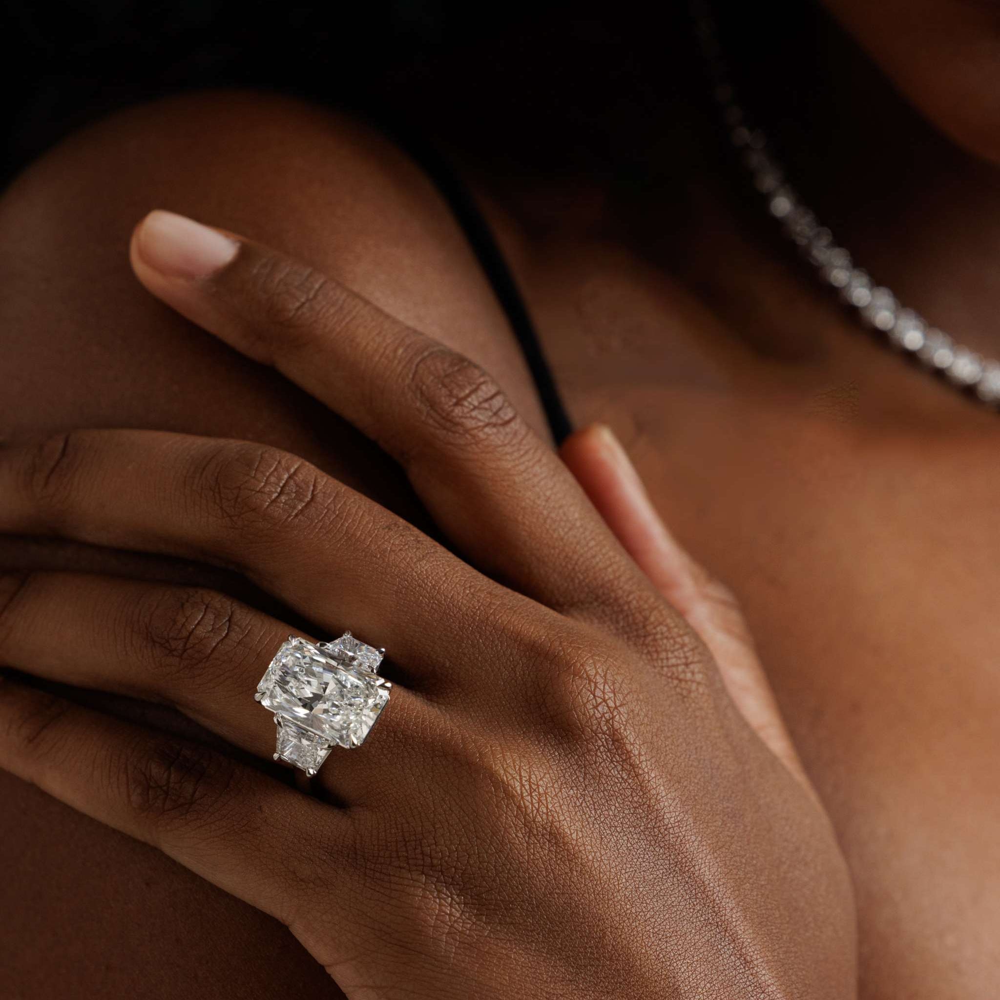 14K white gold engagement ring with 10.05-carat radiant-cut diamond and trapezoid side stones