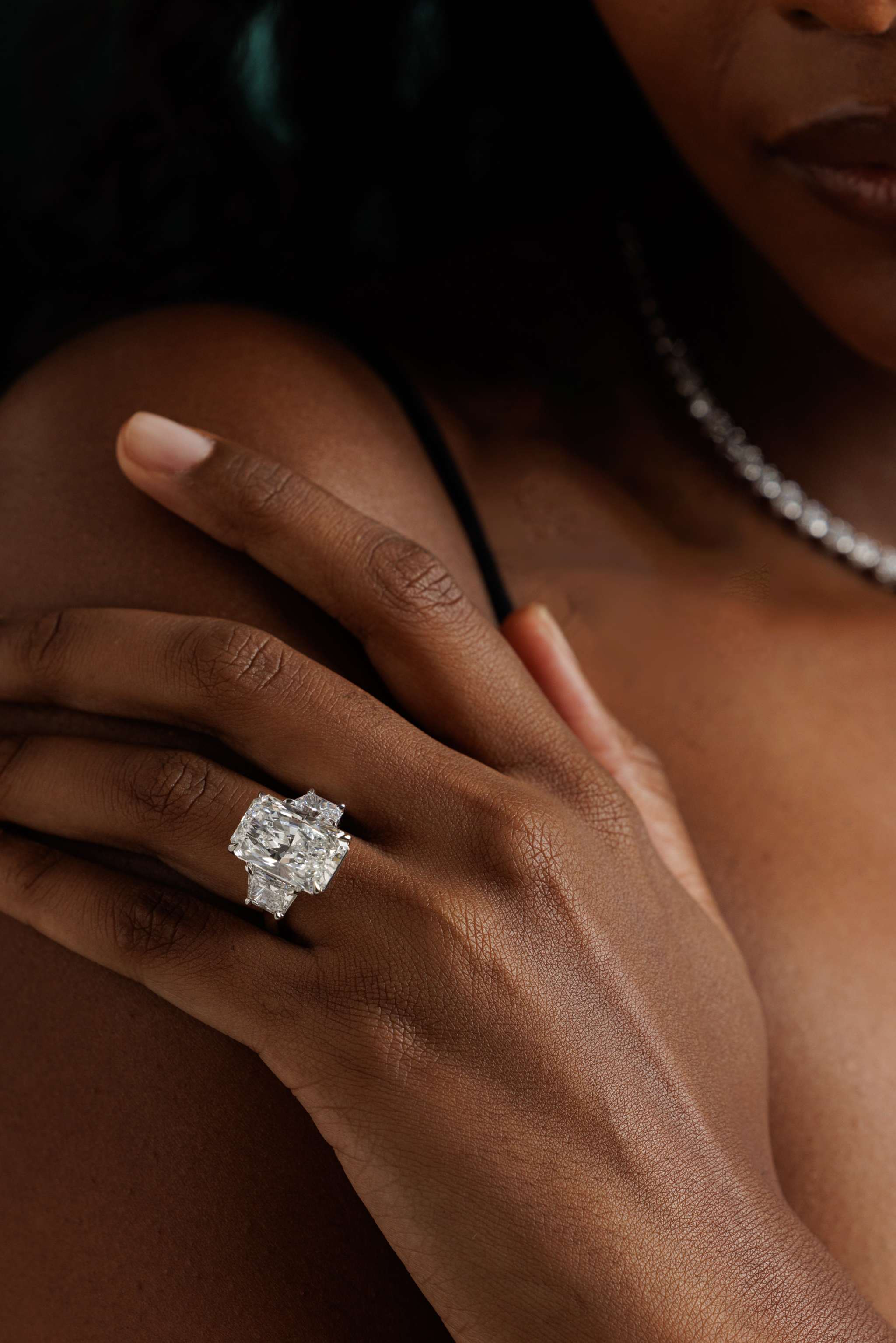 14K white gold engagement ring with 10.05-carat radiant-cut diamond and trapezoid side stones