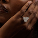 14K white gold radiant-cut three-stone engagement ring with 10.05 carat center diamond and trapezoid side stones