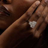 14K white gold radiant-cut three-stone engagement ring with 10.05 carat center diamond and trapezoid side stones