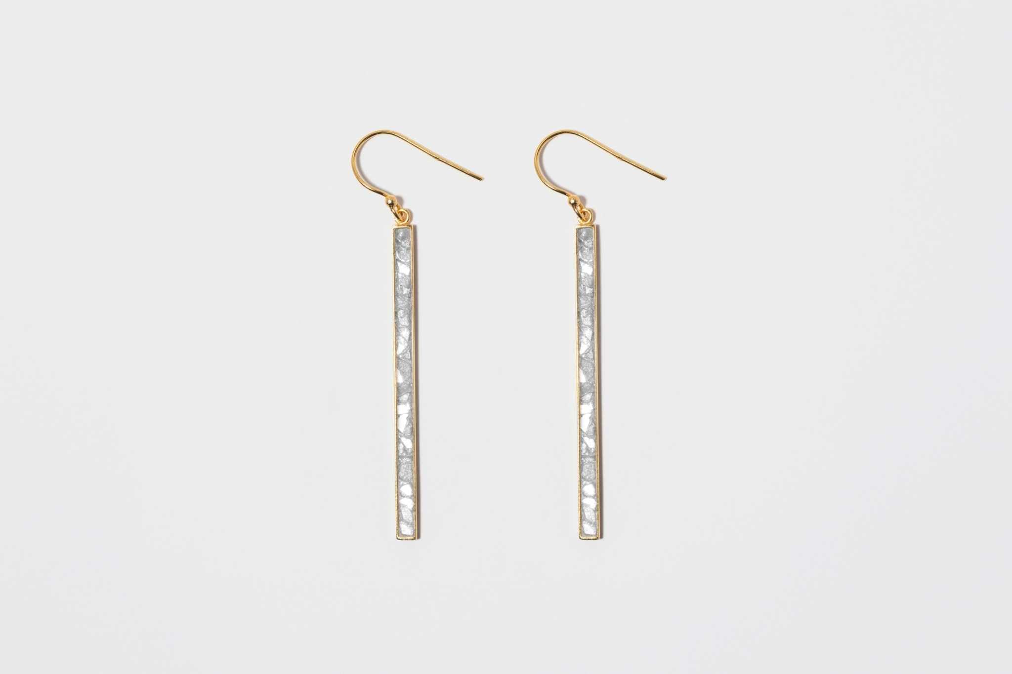 Miladi large gold vermeil earrings with long geometric bars inlaid with raw uncut diamonds and white resin.