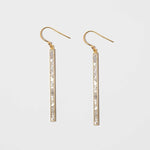 Miladi Large Gold Vermeil Earrings featuring long, geometric gold bars with raw uncut diamonds and sterling silver resin accents.