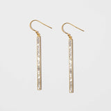 Miladi Large Gold Vermeil Earrings featuring long, geometric gold bars with raw uncut diamonds and sterling silver resin accents.
