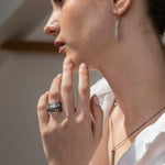 Miladi Small Oxidized Silver Earrings with raw diamond accents on a woman wearing matching oxidized silver rings and necklace