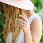 Woman wearing Connecticut Coast Morganite Ring with 10x10mm peach morganite set in 14k gold, styled in natural outdoor setting