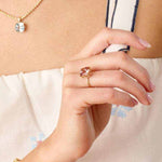 Connecticut Coast Morganite Ring with 10x10mm cushion cut peach morganite set in 14k gold on a woman's hand.
