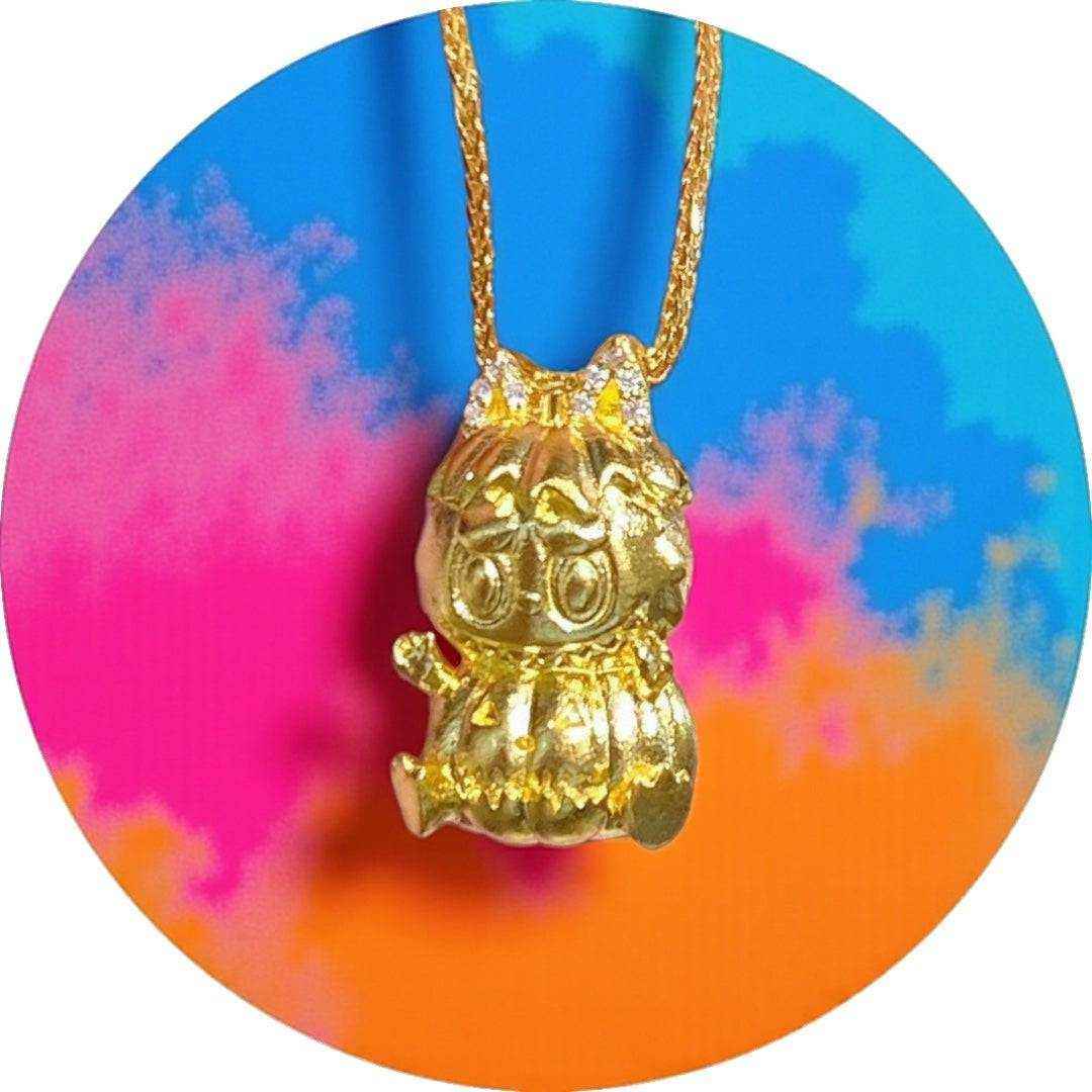 24K gold Labubu-inspired pumpkin sitting doll pendant with sparkling moissanite on gold chain against colorful background