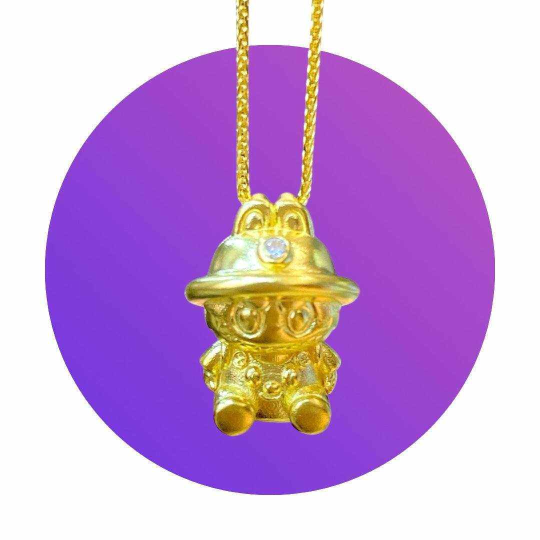 24K gold Labubu-inspired seated doll pendant with sparkling moissanite on purple background
