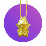 24K gold Labubu-inspired seated doll pendant with sparkling moissanite on purple background