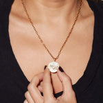 Taurus Gold Vermeil pendant necklace with raw and rose cut diamonds on an 18-inch gold vermeil chain worn on a woman’s neck