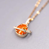 18K yellow gold pendant necklace featuring Mexican Fire Opal with diamond and tsavorite accents